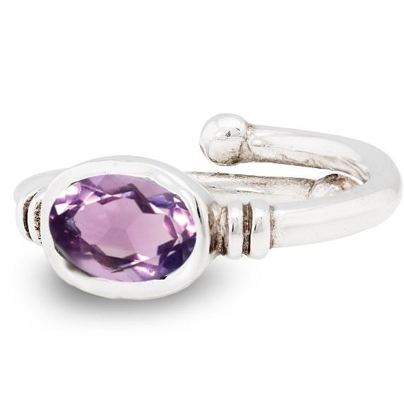 The Senna Ring in various gemstones by Gallardo & Blaine Designs features an oval-shaped, faceted purple gemstone set in a simple, elegant design. The metal is polished, giving it a shiny appearance, and the overall look is classy and refined.