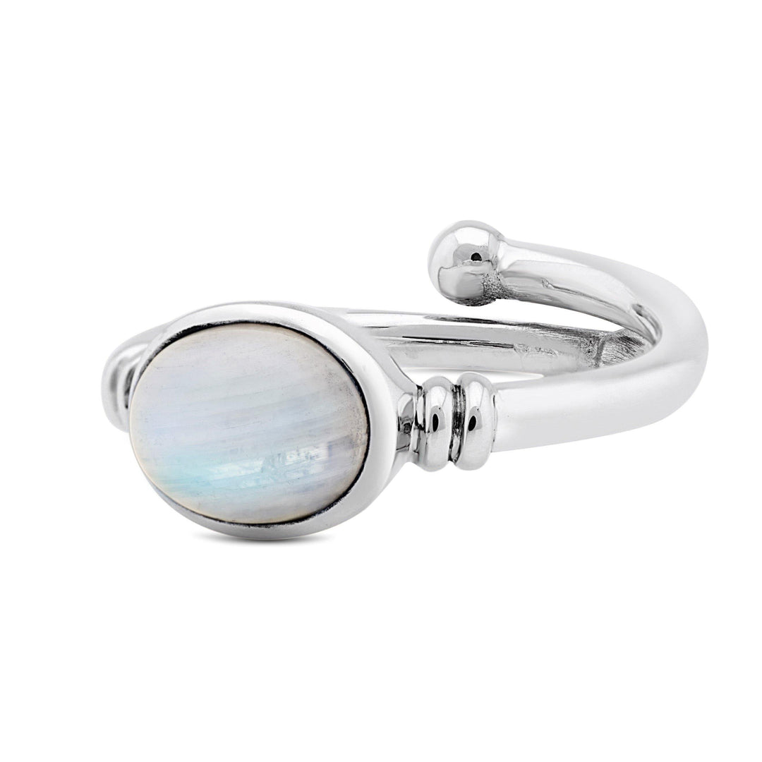 A Senna Ring in various gemstones by Gallardo & Blaine Designs featuring an oval moonstone set in a bezel. The band is polished and reflective with a slight twist near the stone setting, adding an elegant and modern touch to the design.