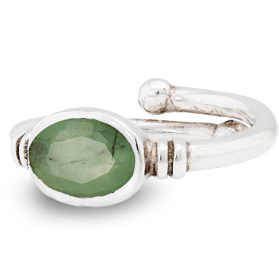 A silver Senna Ring in various gemstones by Gallardo & Blaine Designs featuring an oval-shaped green gemstone set in a simple band. The band has a slight curve, and the faceted gemstone sparkles brilliantly, elevating its elegance.