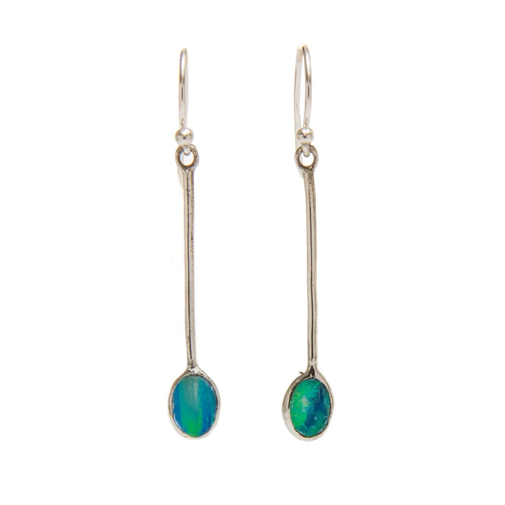 The Sequola Earrings in various gemstones from Gallardo & Blaine Designs are a pair of long, sterling silver drop earrings with slender metal stems, each featuring an oval-shaped blue-green gemstone at the end. These gemstone dangle earrings have a reflective, iridescent quality, while the hooks remain simple and thin for effortless elegance.