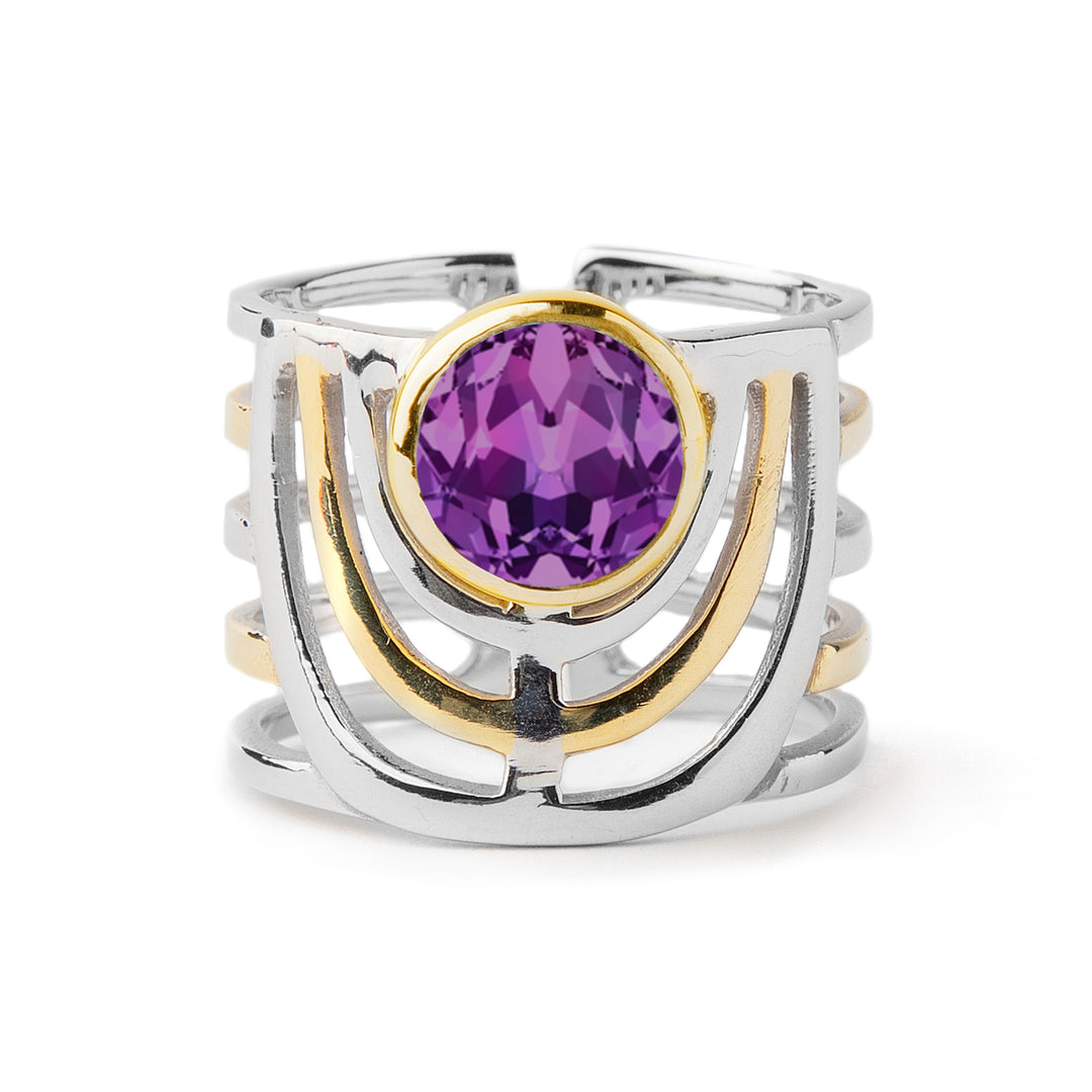 Image of the Gallardo & Blaine Designs Solar Ring in various gemstones, intricately designed and featuring a large, round purple gemstone at the center. The band is crafted from silver and gold, forming an open, lattice-like structure. The bold jewellery design includes three horizontal bands with a semi-circular pattern surrounding the gemstone.