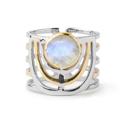 A wide band open ring featuring a central round iridescent gemstone. The Solar Ring in various gemstones by Gallardo & Blaine Designs has a mixed metal design with both silver and gold-toned elements, including geometric patterns and layered bands, giving it a modern, bold jewellery design. The adjustable sterling silver ring ensures a perfect fit.