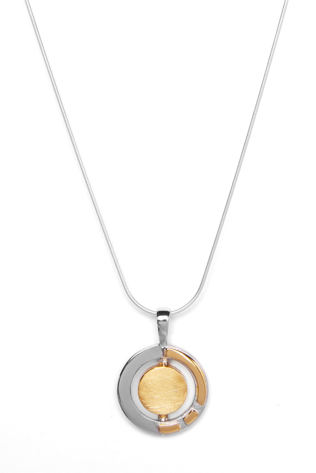 A silver necklace featuring a round, dual-tone Urú Small Pendant & Chain by Gallardo & Blaine Designs. The pendant has concentric circles, with an inner gold-colored circle surrounded by a partial silver ring. The thin, elegant sterling silver chain complements the design beautifully against the white background.