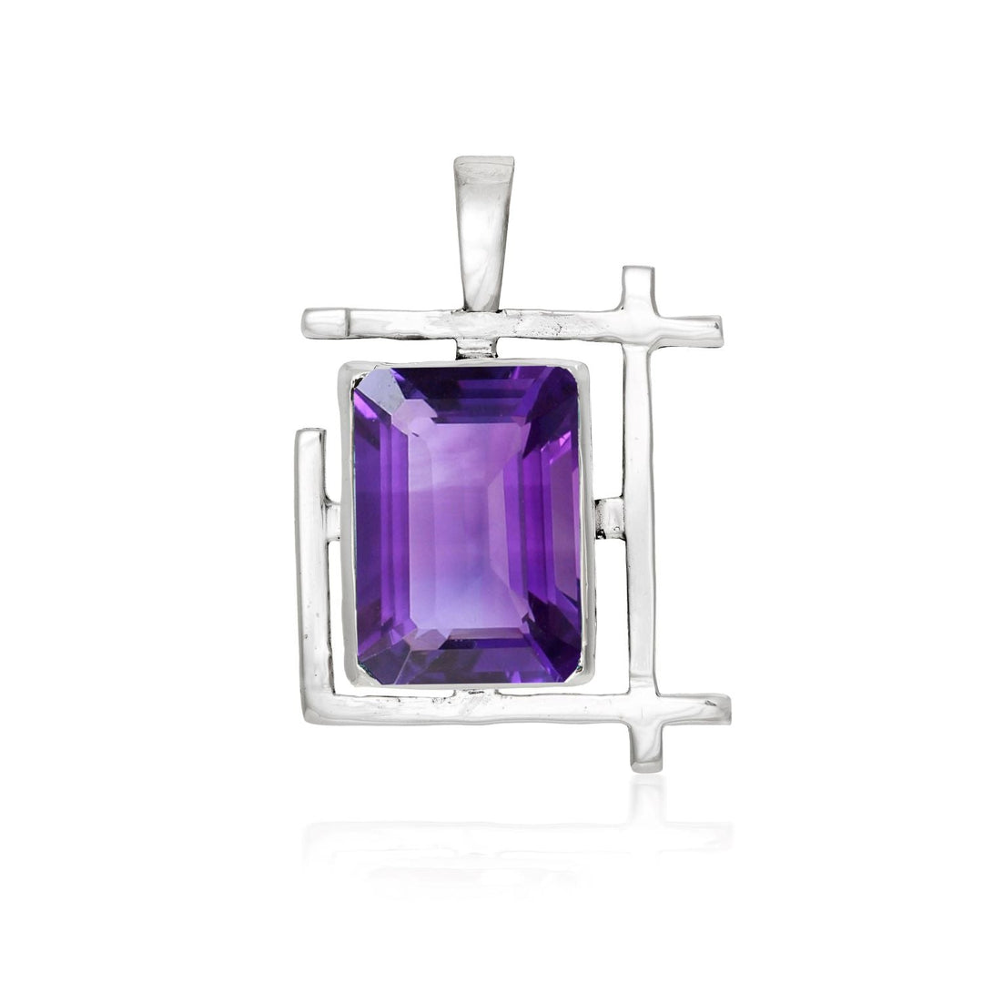 A rectangular Art Deco Pendant in various gemstones by Gallardo & Blaine Designs with a sterling silver frame featuring a large, faceted, rectangular amethyst gemstone in the center. The pendant has a simple, modern design with clean lines and a purple gemstone that stands out against the silver metal.