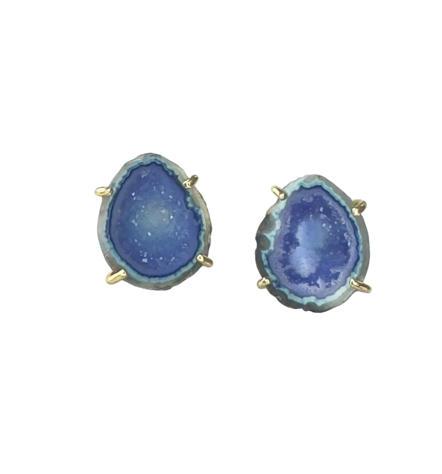 The Geode Tassel Earrings by Aria V feature irregular oval aqua blue geodes set in gold prongs, shown against a plain white background.