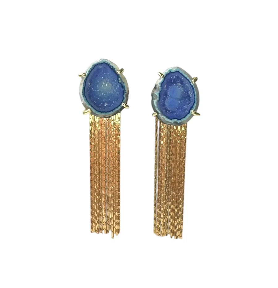 Aria V Geode Tassel Earrings feature aqua blue geode stones at the top and multiple long gold chain tassels, creating a striking look.