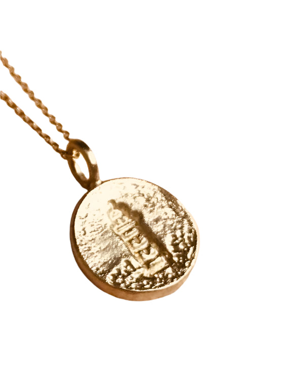 9 carat yellow gold disc lighthouse pendant on a 9ct gold chain