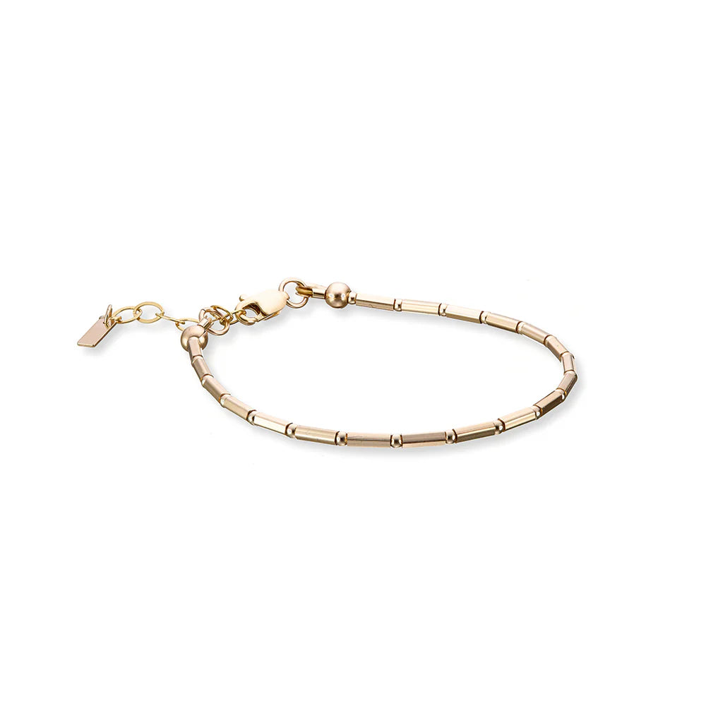 fine gold bracelet with tube style beads and an extension chain. 