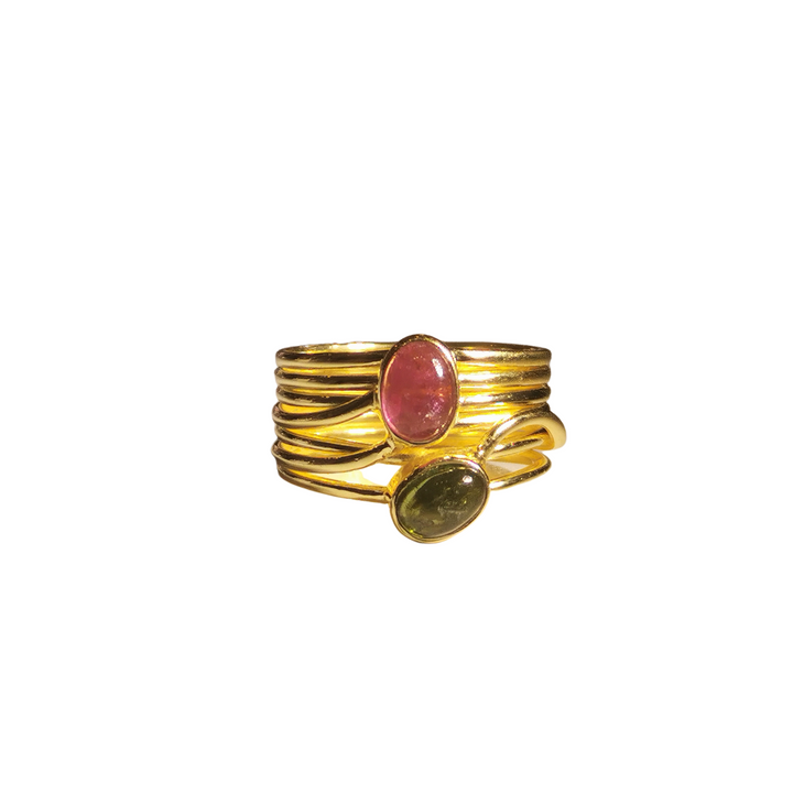 The Green and Pink Tourmaline in a Multi Band Gold Ring by Watermelon Tropical features two oval tourmaline gemstones: a red one at the top and a dark green one at the bottom. This piece of handmade jewellery has a modern, intertwined design.