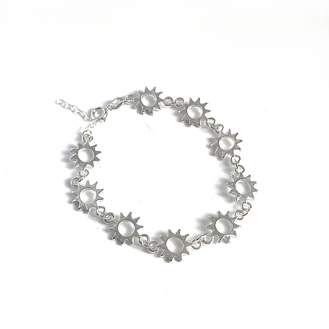 The Helios Bracelets by Inó Jewellery are handmade from sterling silver, featuring sun-shaped charms with circular centers and displayed on a white background.