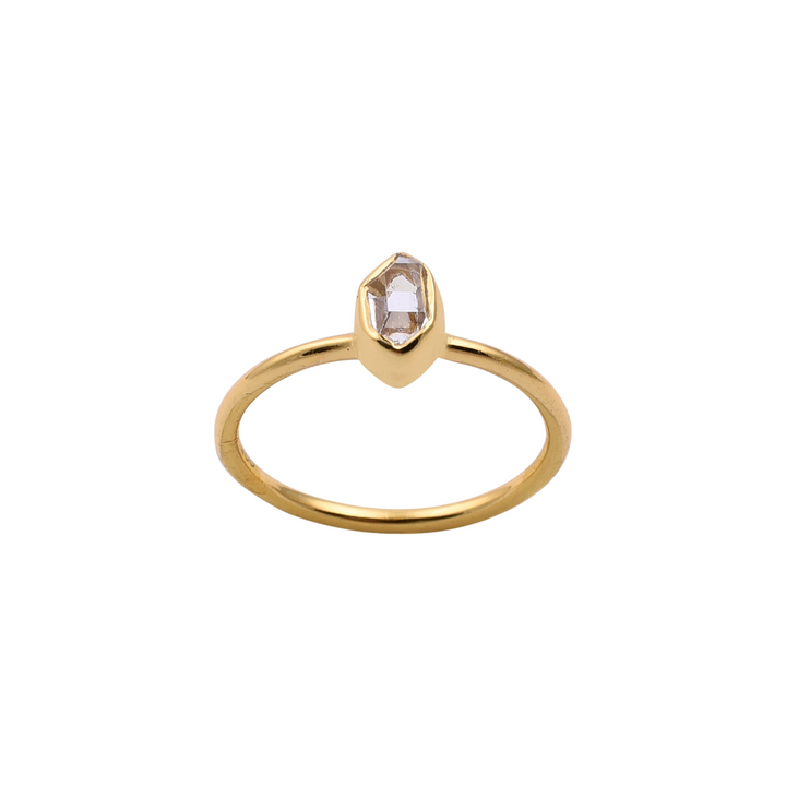 The Herkimer Quartz Gold Ring by Watermelon Tropical features a single Herkimer Quartz gemstone set in a geometric, bezel-style setting. The band is thin and smooth, showcasing the unique, faceted stone at the center. This piece of handmade jewellery captures elegance in simplicity.