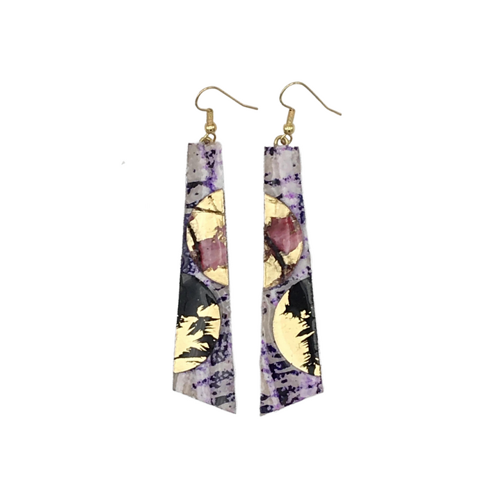 Introducing the Rothlú Hoop-La Batik Textile Earrings in Purple, Red, Black, and Gold—geometric dangle statement earrings featuring a mix of vibrant colors with abstract patterns. These hypo-allergenic earrings boast a thin, elongated shape with gold hooks and are adorned with circular gold accents and a unique marbled texture.