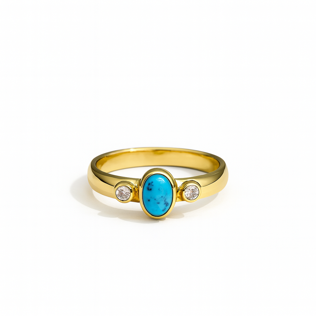 The Howlite & cubic zirconia gold ring by Watermelon tropical features a central oval howlite stone with two round cubic zirconias, shown on a white background—a striking piece of handmade jewelry.