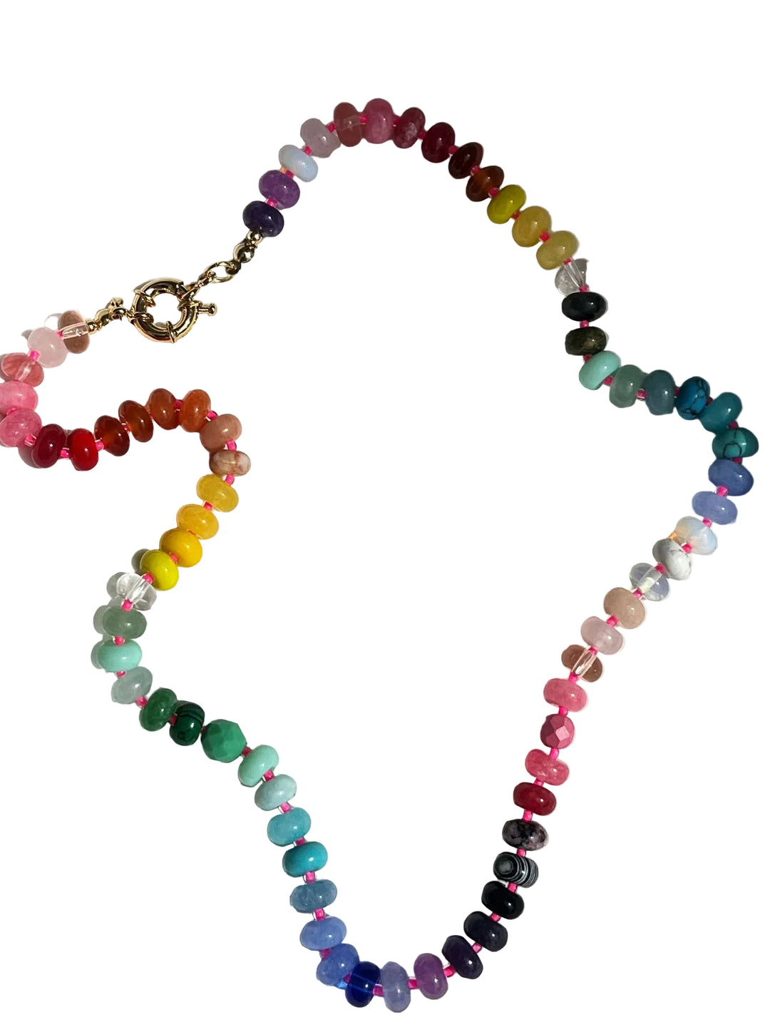 Multicolored beaded necklace on a white fabric background