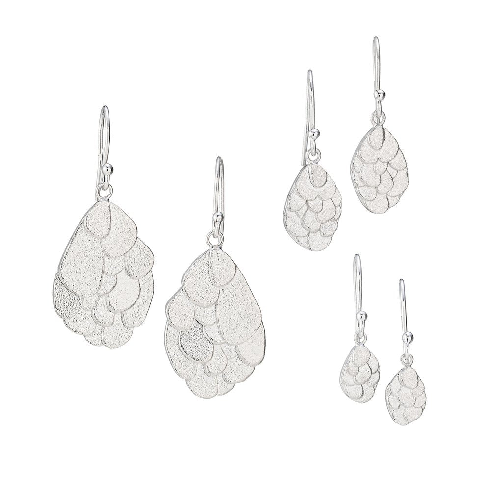 A set of three pairs of Leoma Drew Kimana Drop Earrings in Frosted Silver with a cluster design. The earrings increase in size from top to bottom, featuring a teardrop shape comprised of overlapping, textured, leaf-like segments.