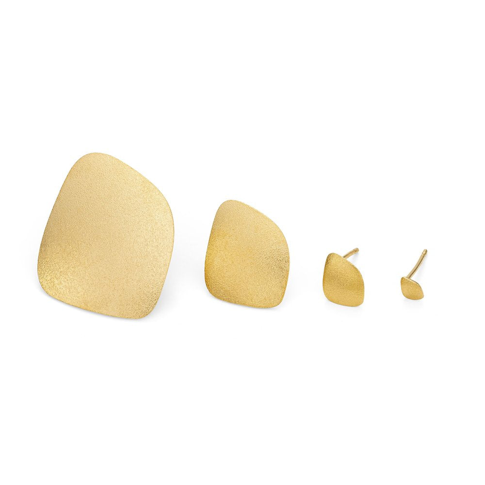 A pair of gold-tone, abstract-shaped stud earrings with a frosted finish. The set includes two sizes, featuring one larger and one smaller earring for each ear, laid out on a white background. These are the Freeform Wing Studs Gold by Leoma Drew.