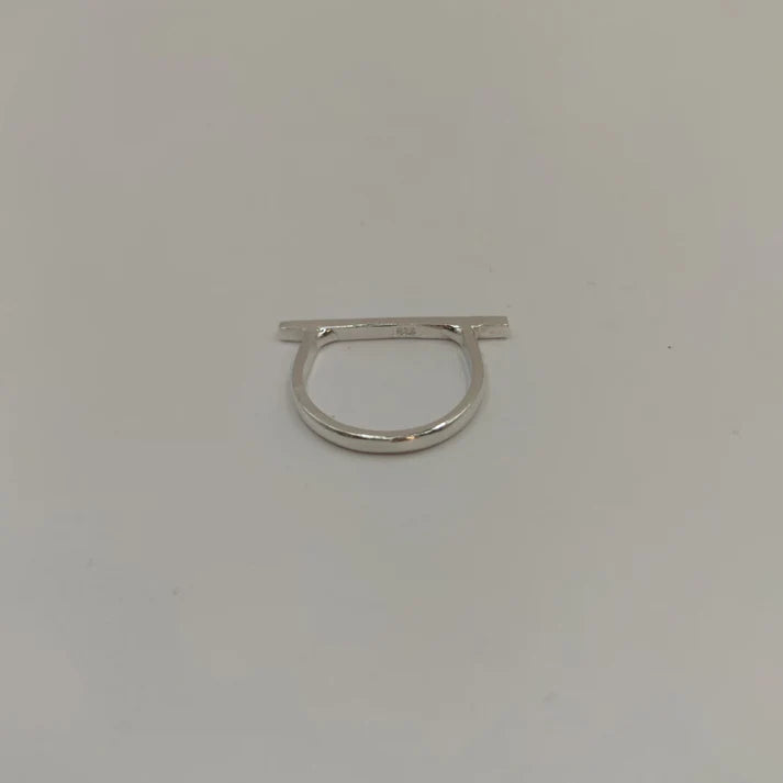 The Line Silver Ring by Inó Jewellery is a minimalist sterling silver ring featuring a flat horizontal bar, shown on a plain white background.