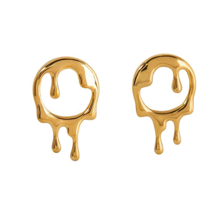 A pair of Dripping Rivulets Stud Earrings Gold designed to resemble melting liquid. Both earrings, crafted from handmade sterling silver with 18K yellow gold plating, have an abstract, rounded circular shape with drip-like extensions hanging down, creating a dynamic and artistic appearance. The background is plain white. These striking earrings are from Marie June Jewellery.