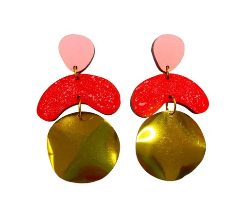 The Galaxy Megadrop Earrings in Red and Pink by Shock of Grey feature handcrafted pink teardrop tops, bold red curves, and large gold pendants—an eco-friendly statement accessory.