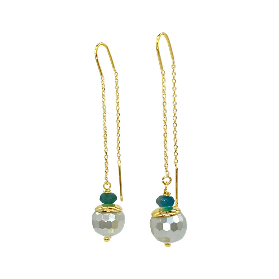 The Mimi Earrings by Aria V feature gold dangling chains with faceted silver beads and teal accents. These handmade, minimalist aquamarine earrings offer elegant style, ideal for lovers of Irish jewelry craftsmanship.