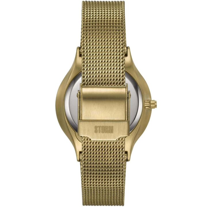 A Storm Mini Sotec Gold Teal watch with a round face and minimalistic design, viewed from the back. The watch features edge-to-edge glass and a metal clasp closure. The finely woven band provides a sleek, modern look. The brand name "Storm Watches" is engraved on the clasp, highlighting its commitment to sustainable materials.