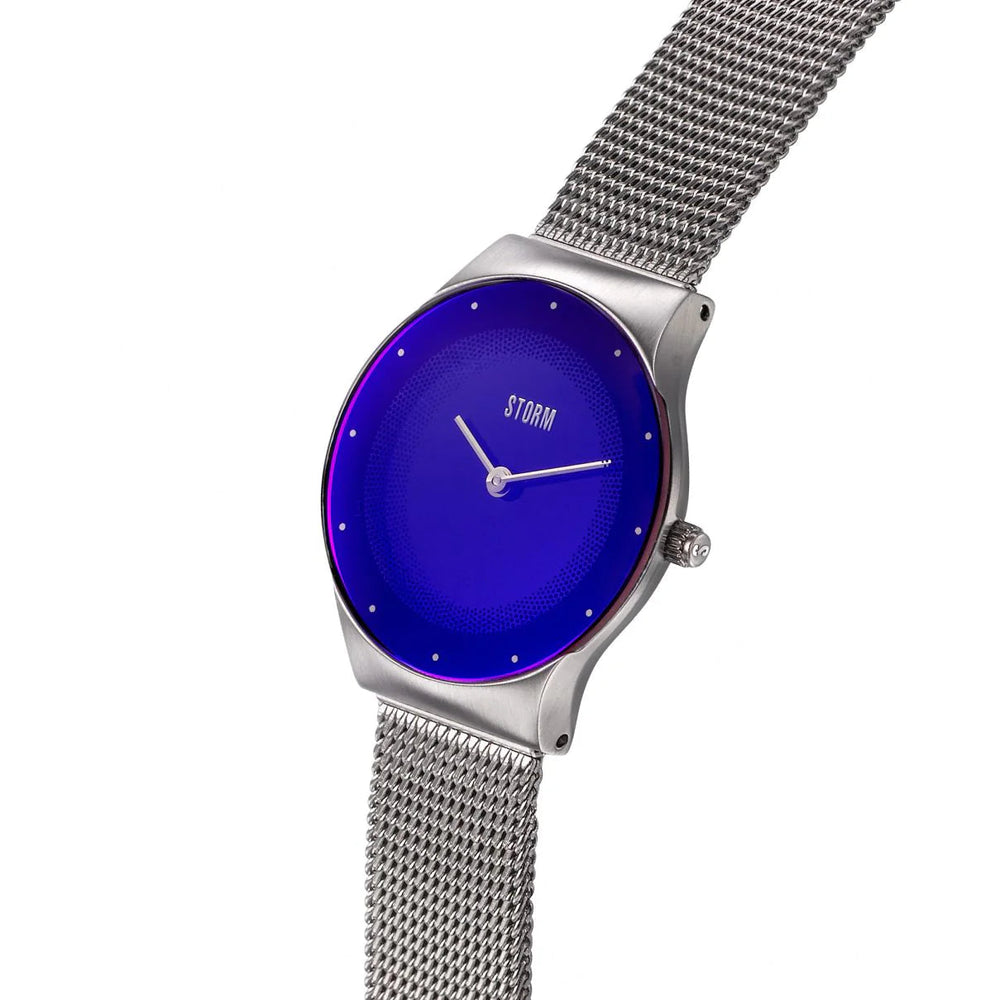 A sleek wristwatch with a minimalist design, the Storm Mini Terelo Lazer Blue features a vibrant blue circular face, silver hour and minute hands, and the brand name "Storm Watches" in silver lettering. The watch boasts a silver mesh band made from sustainable materials and a slim, polished metallic casing.