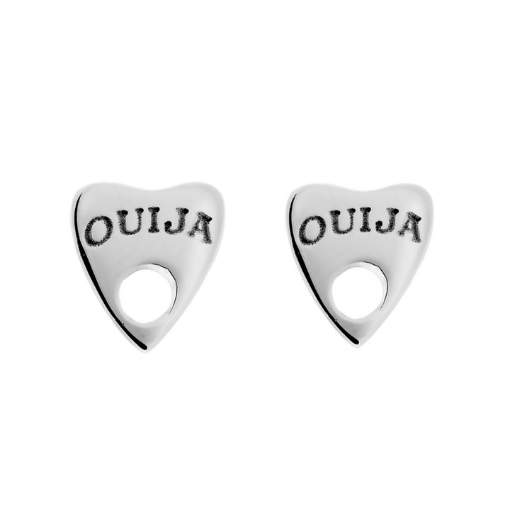 A pair of Ouija Silver Earrings by Cosmic Boulevard shaped like Ouija board planchettes. Each earring features "Ouija" engraved at the top, with a circular hole in the lower part of the design. The handmade jewellery boasts a smooth and polished appearance, perfect for adding a touch of mystique to any outfit.