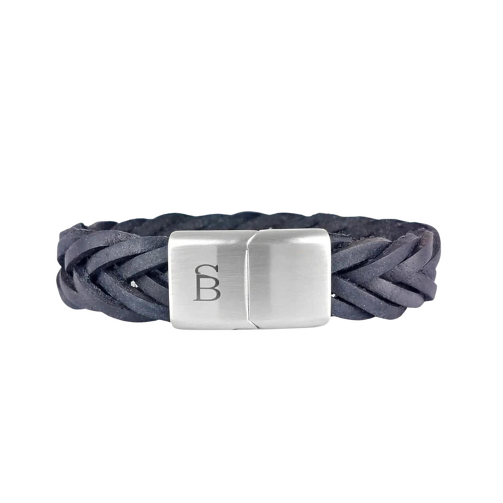 A braided black genuine leather bracelet with a rectangular silver clasp. The clasp features a subtle engraved design resembling the letter "B". This masculine wristwear boasts a sleek and modern appearance. Introducing Preston - Navy by Steel and Barnett.