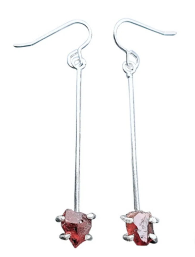 Caroline Stokesberry-lee Raw Garnet Drop Earrings featuring a long sterling silver bar with a raw, red garnet stone at the base.