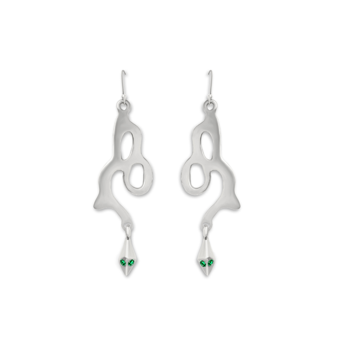Add a unique touch to your collection with Serpent Earrings by Madeleine Sculptural Jewellery—silver earrings featuring abstract, flowing shapes and dangling tips adorned with two green gemstones, evoking the look of snake eyes.