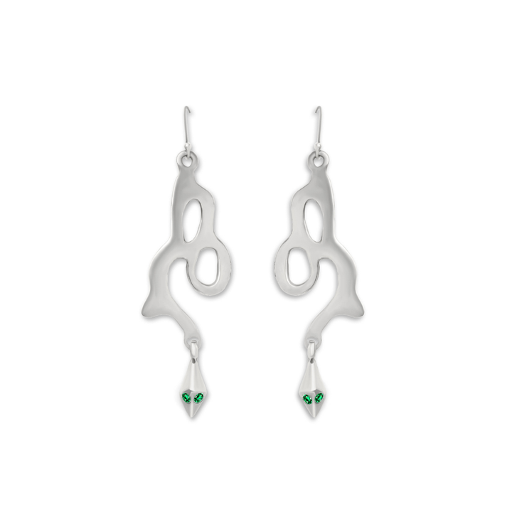 Add a unique touch to your collection with Serpent Earrings by Madeleine Sculptural Jewellery—silver earrings featuring abstract, flowing shapes and dangling tips adorned with two green gemstones, evoking the look of snake eyes.