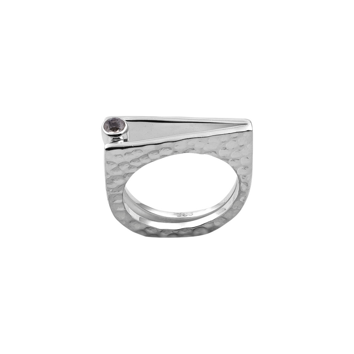 A beautiful piece of handmade jewelry from Watermelon Tropical, the Silver Bar Rainbow Moonstone Ring features a sterling silver construction with a textured, hammered finish. Its sleek, geometric design includes a flat, triangular top adorned with a small round rainbow moonstone set near one corner, creating a unique and contemporary aesthetic.