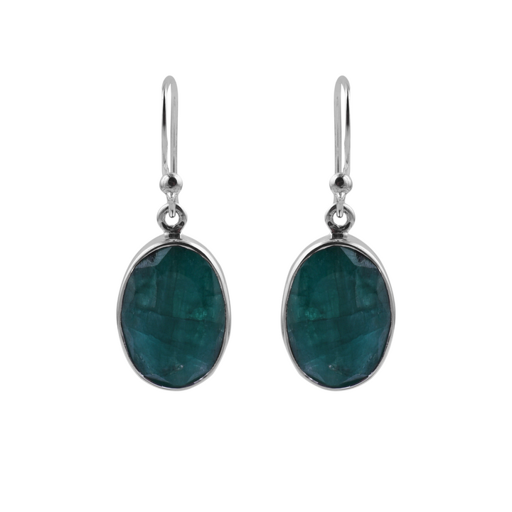 A pair of elegant, oval-shaped, rough emerald earrings set in sterling silver with a simple hook design. The gemstones have a smooth, polished surface and are the focal point of these minimalist, contemporary dangling earrings from Watermelon Tropical. Introducing the Simple Silver & Rough Emerald Oval Earrings by Watermelon Tropical.