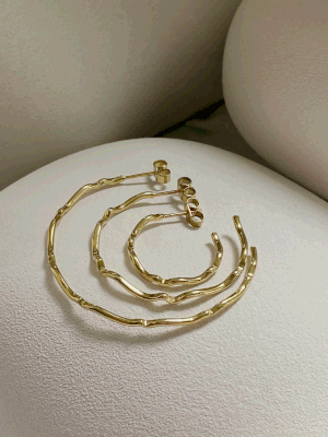 The Sister Hoops jewelry set by Inner Island, featuring a gold twisted necklace, bracelet, and hoop earrings, is displayed on soft cream fabric—a versatile collection ideal for jewellery lovers.