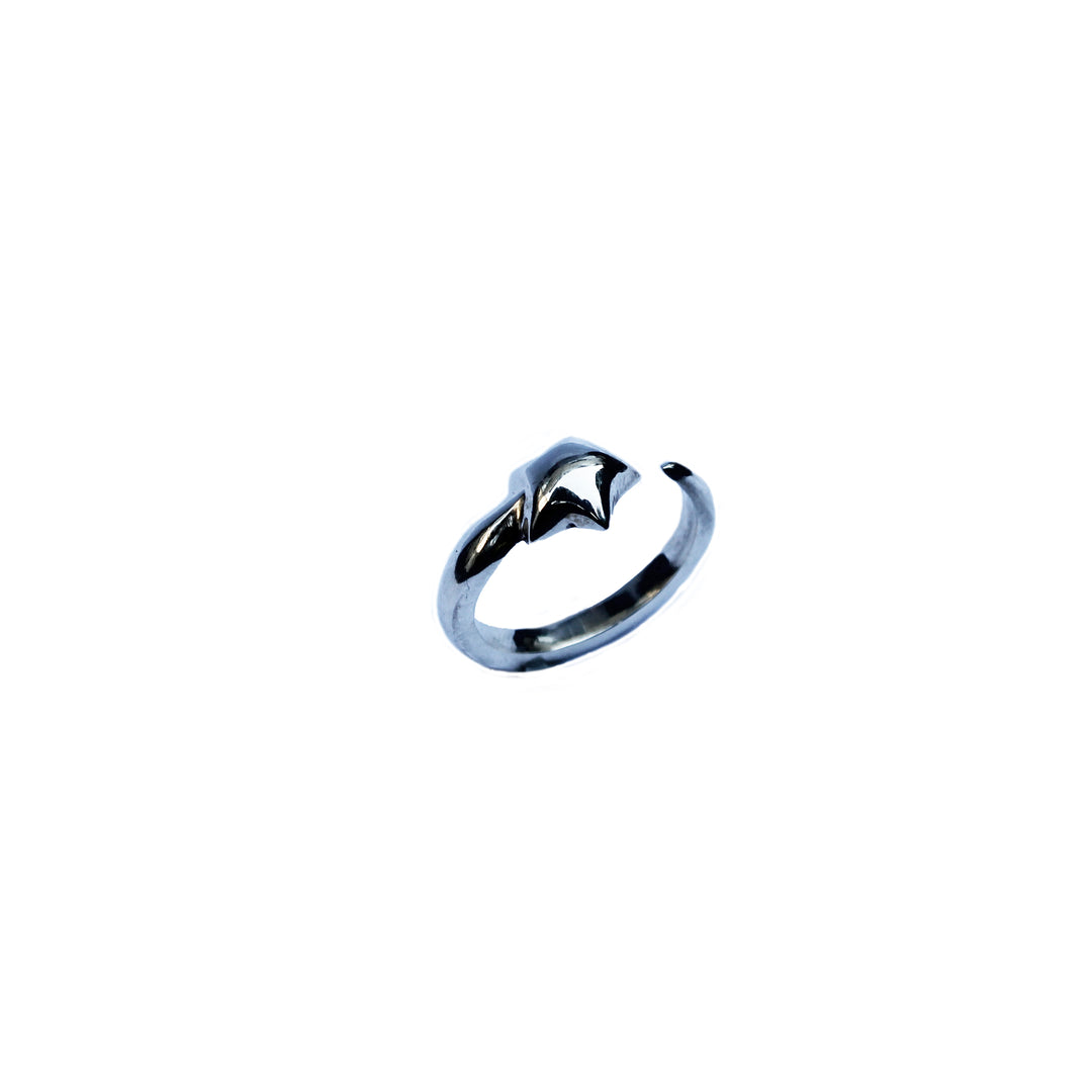 The Kate Murphy Shooting Star Silver Ring features a minimalist, star-inspired open design in silver and is shown on a plain white background.