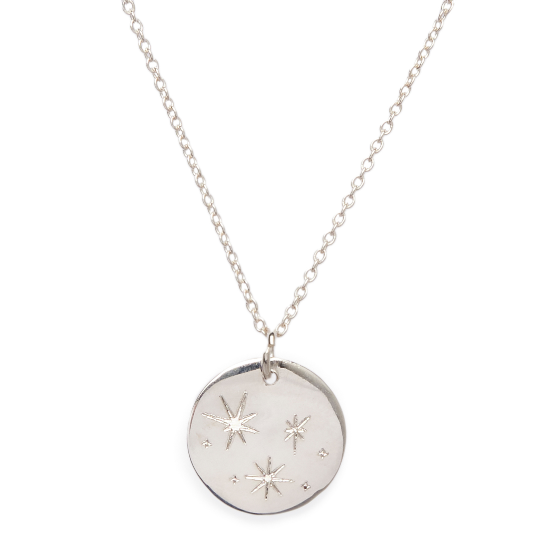 The Symbol Necklace by Personalised Charms features a round pendant engraved with three stars and dot accents on a delicate chain—an ideal choice for personalized jewelry.
