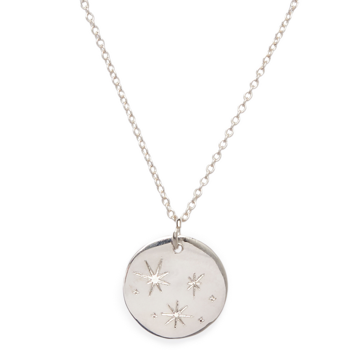The Symbol Necklace by Personalised Charms features a round pendant engraved with three stars and dot accents on a delicate chain—an ideal choice for personalized jewelry.