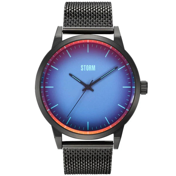 A wristwatch featuring a blue and red gradient dial with minimalist design. The Storm Watches Storm Styro Slate Blue watch boasts a black stainless steel mesh band, and the word "STORM" is displayed at the 12 o'clock position. It also includes three hands for hours, minutes, and seconds and is crafted with sustainable materials.