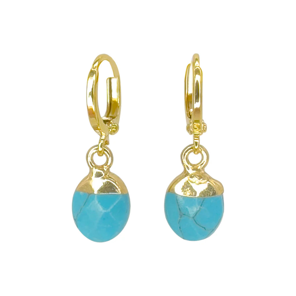 Aria V’s Turquoise Drop Earrings feature gold hoops with dangling oval turquoise stones and gold accents, each handcrafted in Dublin for a distinctive touch.