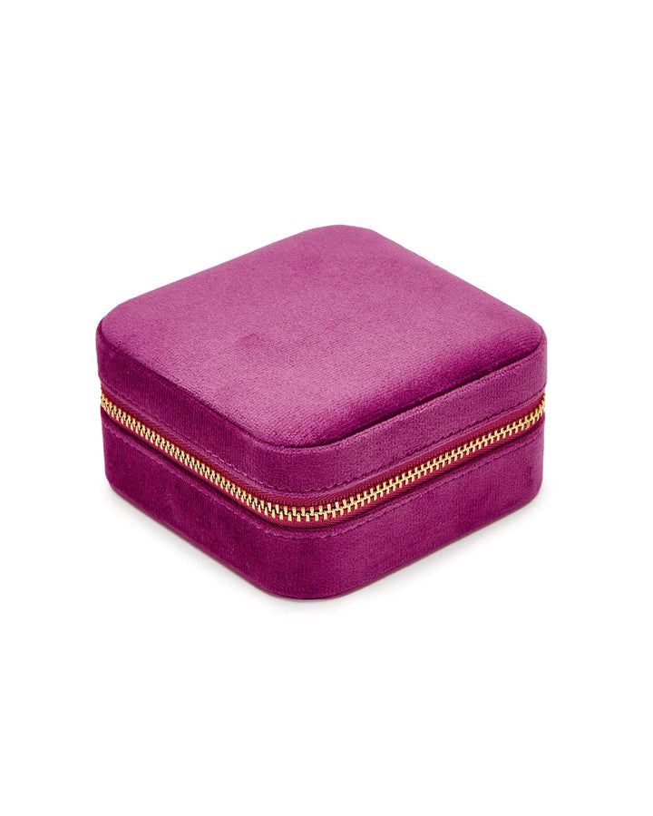 A SoCases Luxurious Wildberry Velvet Travel Jewellery Box, covered in vibrant purple velvet with a gold zipper around its edge, perfect for travel jewelry storage.