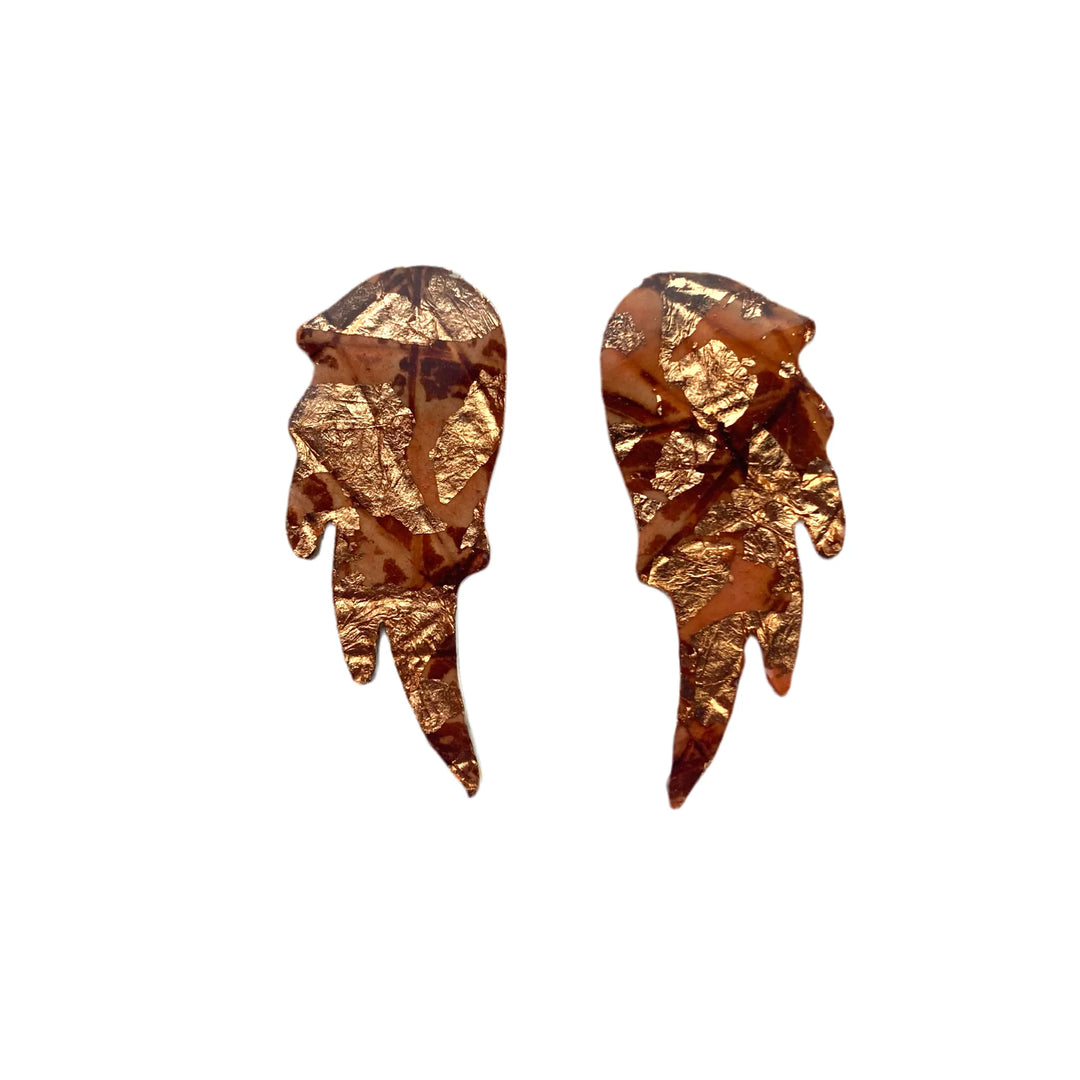Rothlú’s Wings of Desire Sgraffito Stud Earrings feature a metallic gold, abstract angel wing design with a crinkled texture, shown on a white background.
