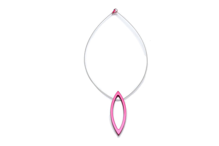 Introducing the Large Navette Pendant by Filip Vanas, a minimalist necklace that showcases a stainless steel string with an elongated pink pendant at its center. The anodized aluminum pendant features smooth edges and is hollow, suspending gracefully from a small pink bead. The sleek design stands out beautifully against a white background.