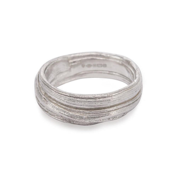 A Mitsuro Silver Ring by Abbie Dixon with a textured, grooved design running horizontally around the band. The ring's slightly uneven surface gives it a unique, artisanal look reminiscent of a Mitsuro Hikime ring made using the lost wax method. The interior of the band features small engravings.