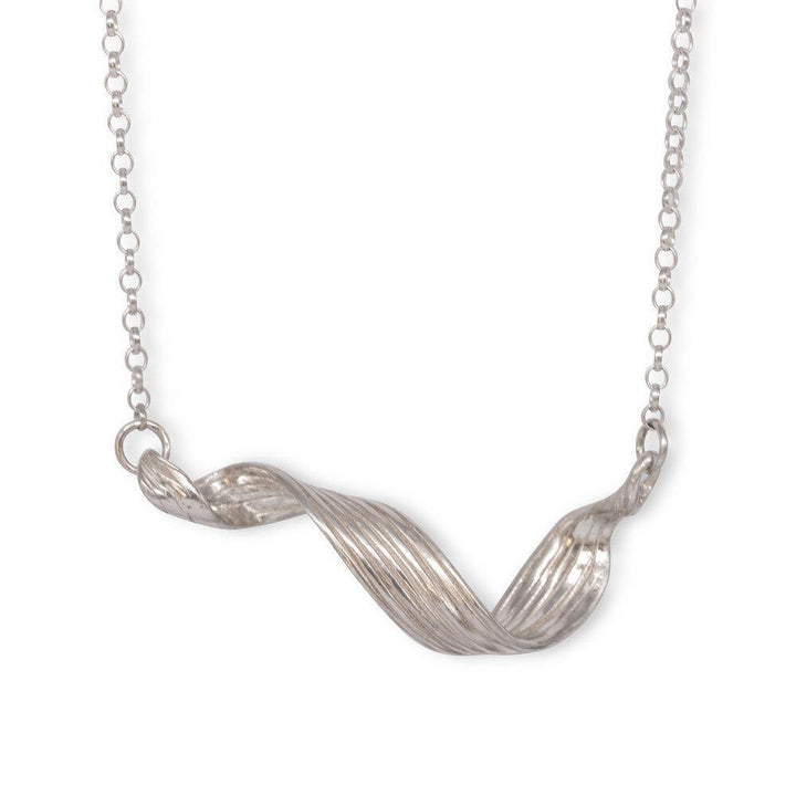 The Mitsuro Ribbon Neckpiece by Abbie Dixon features a delicate chain with a twisted, ribbon-like pendant. The pendant, elegantly curved and textured in the Mitsuro Hikime style, hangs horizontally at the center, creating a simple yet sophisticated design.