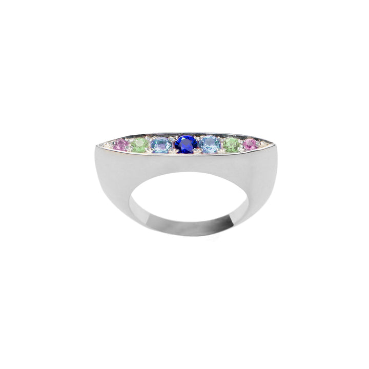 A sleek and modern sterling silver ring featuring a row of multicolored gemstones, including sapphires in green, blue, and purple hues, set along the top surface. The design boasts a smooth, polished finish. This exquisite piece is the Eveningstar Sapphire Ring by Cosmic Boulevard.