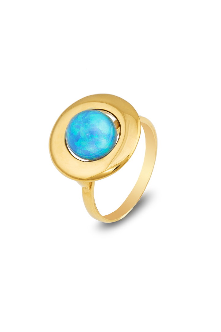 A Home Planet Blue Sky Opal 9ct Gold ring from Cosmic Boulevard featuring a round, sky blue opal gemstone set in the center. The band is simple and elegant, highlighting the striking opal. The design is modern and minimalist, with the gemstone as the focal point. The ring is photographed on a plain white background.