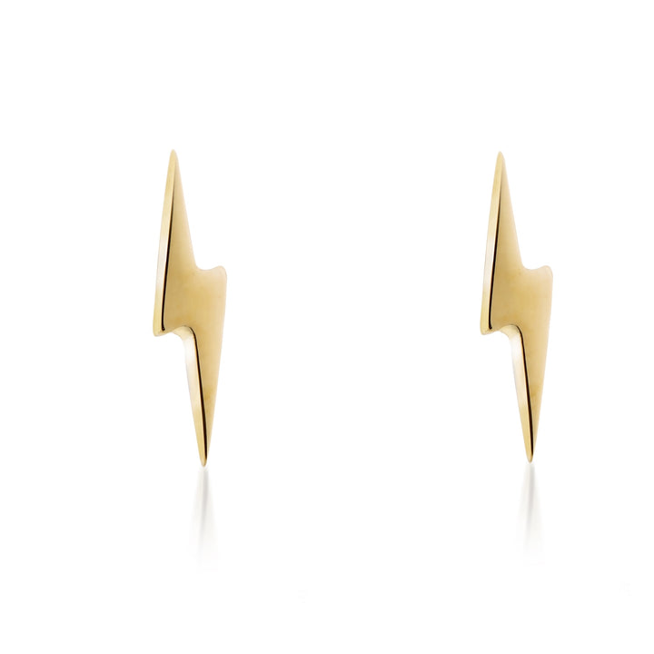 A pair of Tiny Lightning Bolts 9ct Gold by Cosmic Boulevard, crafted from gold, are displayed against a white background. The earrings are sleek and minimalist in design, featuring smooth surfaces and sharp angles. They are positioned vertically and face each other.