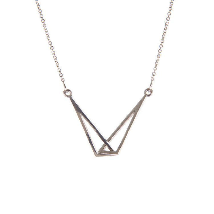 A Miriam Wade Le Cheile Pendant Small Silver featuring a geometric pendant with two overlapping, open triangles, suspended from a delicate chain. The design is minimalistic and modern, perfect for those who appreciate dainty jewellery.