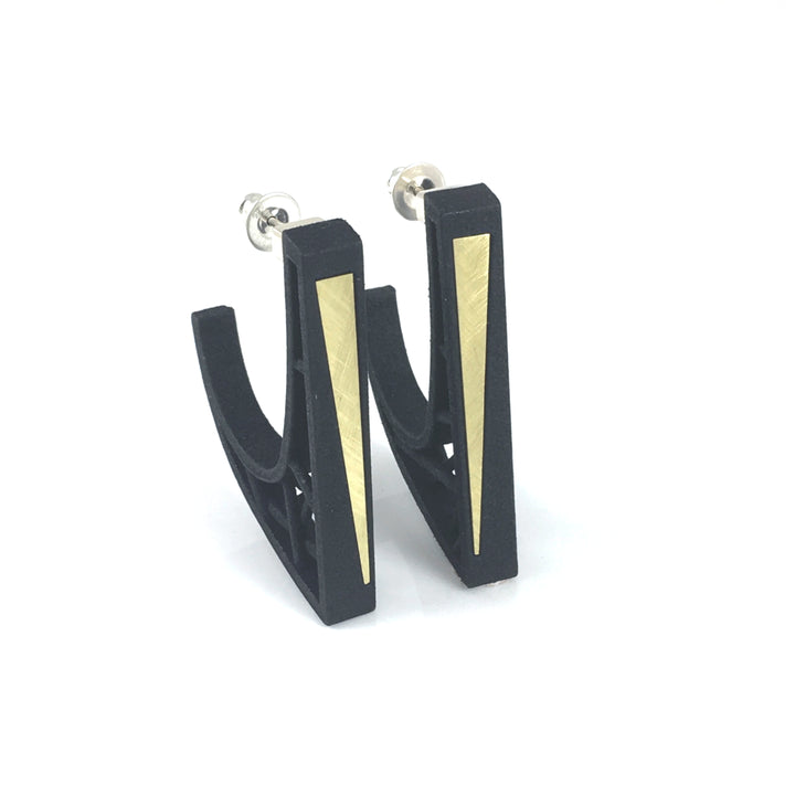 A pair of black, geometric-shaped Hebo Earrings from Elsiem featuring a gold-colored inlay along one side. The earrings, made from SLS Nylon, boast a modern, minimalist design and are displayed on a white background. The fastening posts are sterling silver ear posts.