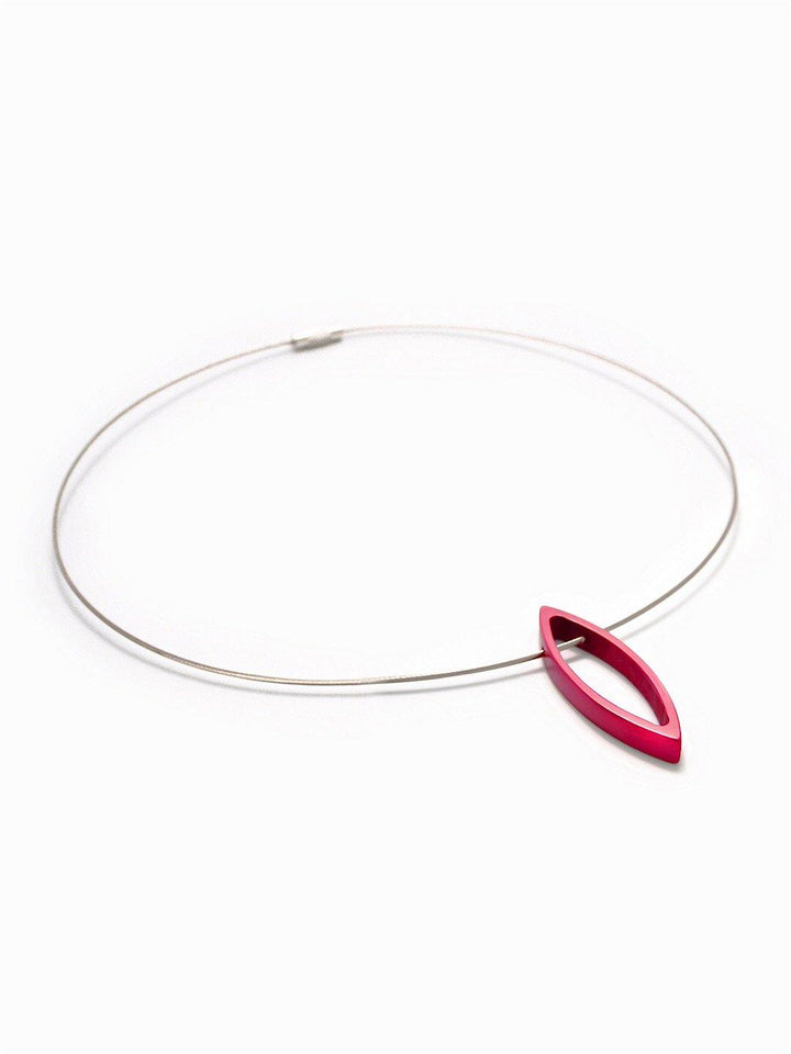 A minimalist necklace consisting of a thin, stainless steel cord with a small, sleek, Small Navette Pendant in vibrant pink by Filip Vanas. The navette pendant is hollow, adding a modern and elegant touch to the overall design. The background is plain white.